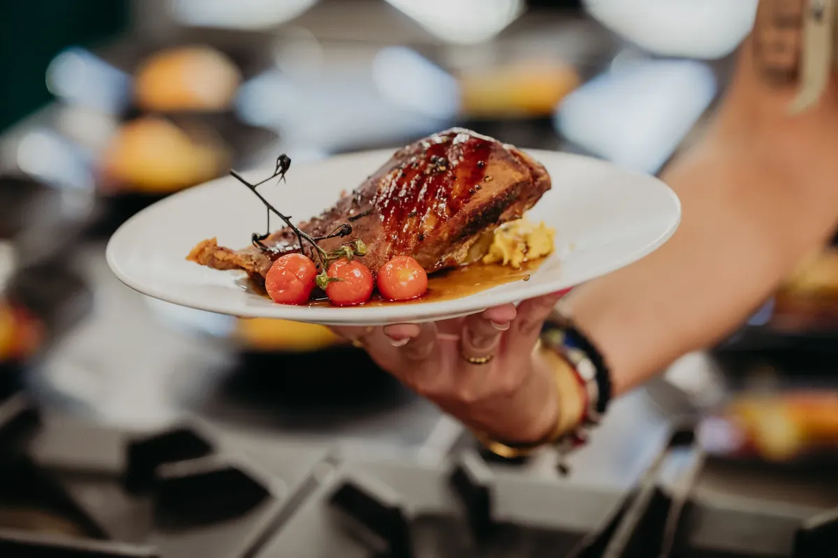 A plated dish carried from the pass in the kitchen at Sierra Recovery.