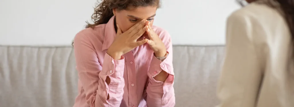 Woman with hands on face worried