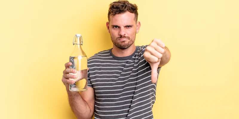 sierra recovery alcohol detox young man holding beer bottle pointing