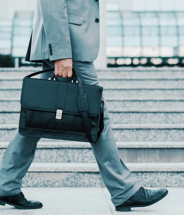 sierra recovery executive man suit carrying briefcase