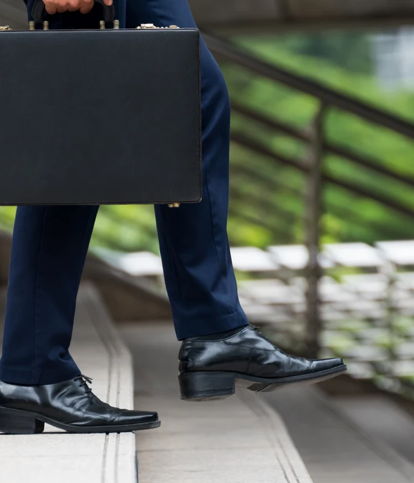 sierra recovery executive man suit tie holding briefcase