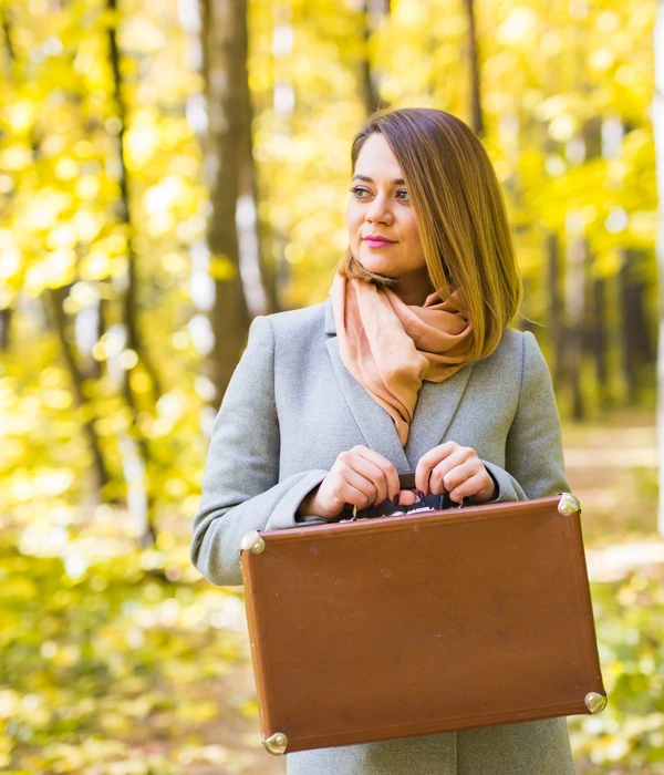 sierra recovery executive woman suit tie holding briefcase