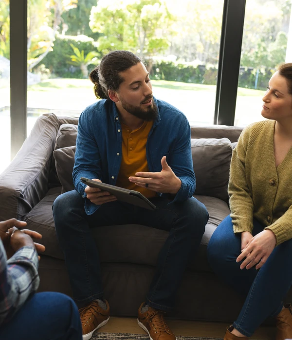sierra recovery group therapy man woman sitting couch looking tablet