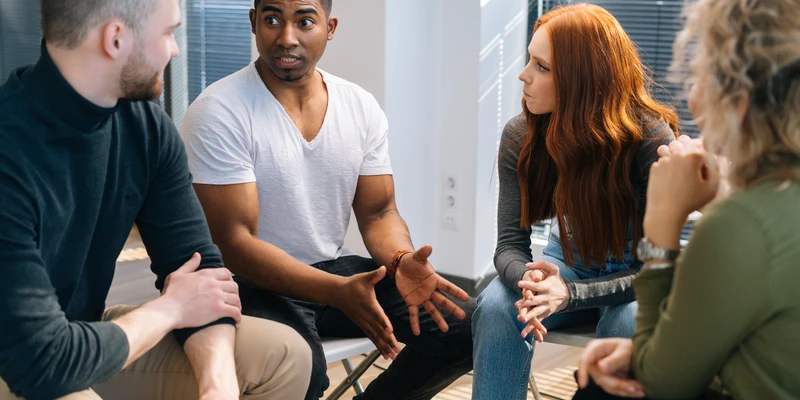 sierra recovery group therapy people sitting around table talking