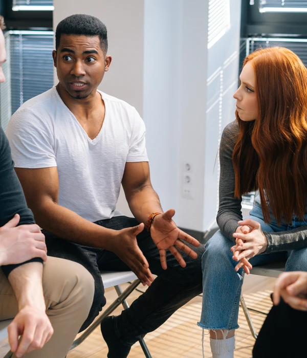sierra recovery group therapy people sitting around table talking