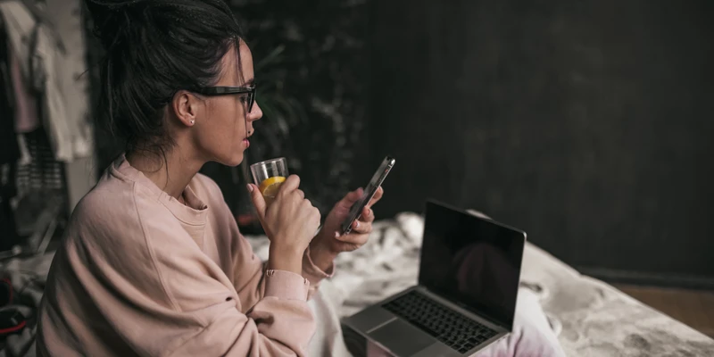 sierra recovery internet addiction woman sitting bed using phone