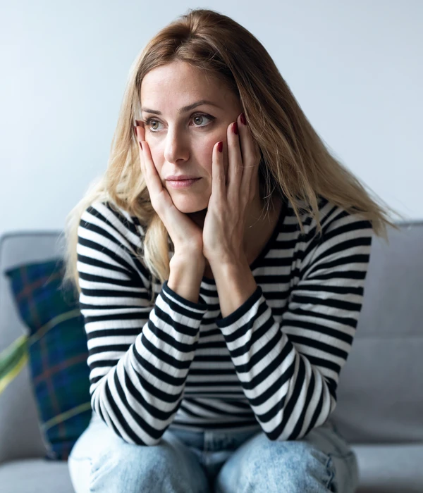 sierra recovery mental health woman sitting couch hands face