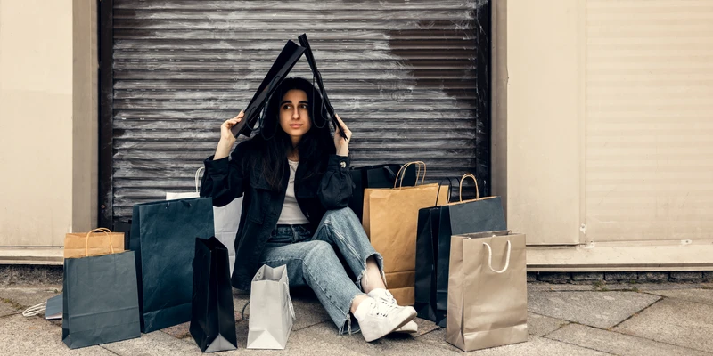 sierra recovery shopping addiction woman sitting ground bags