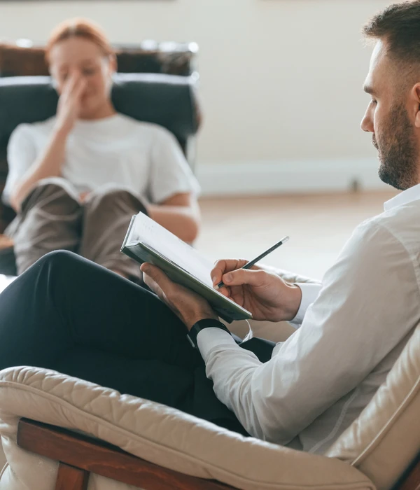 sierra recovery therapy man sitting chair book woman background