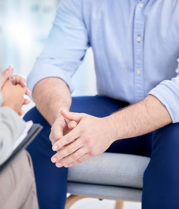 sierra recovery therapy man sitting couch hand knee