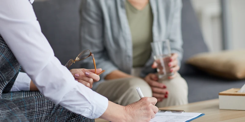 sierra recovery therapy two people sitting table papers pen