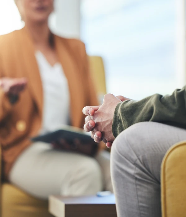 sierra recovery therapy woman sitting couch hand back man