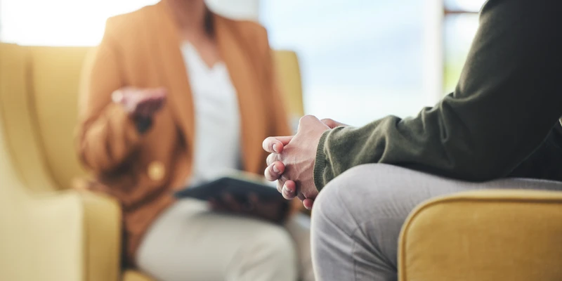 sierra recovery therapy woman sitting couch hand knee