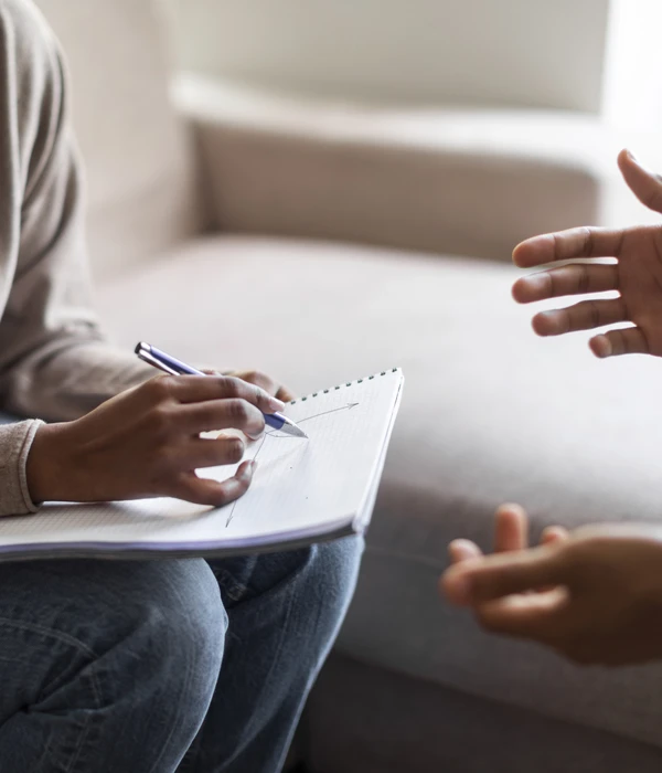 sierra recovery therapy woman sitting couch note pad pen