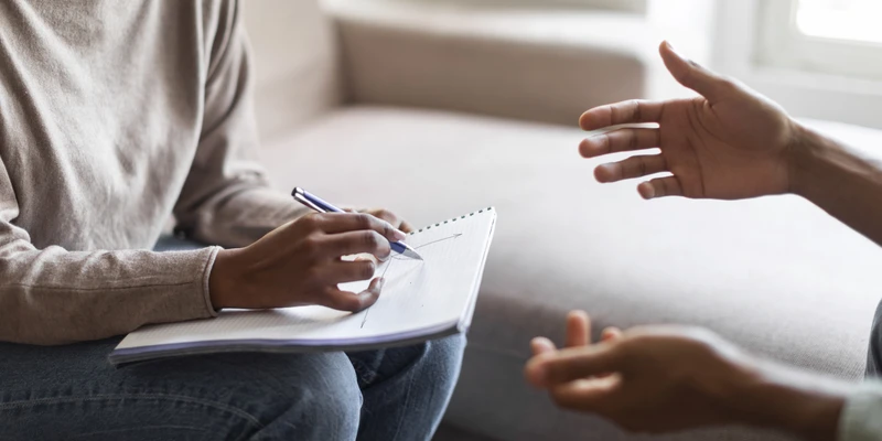 sierra recovery therapy woman sitting couch talking man