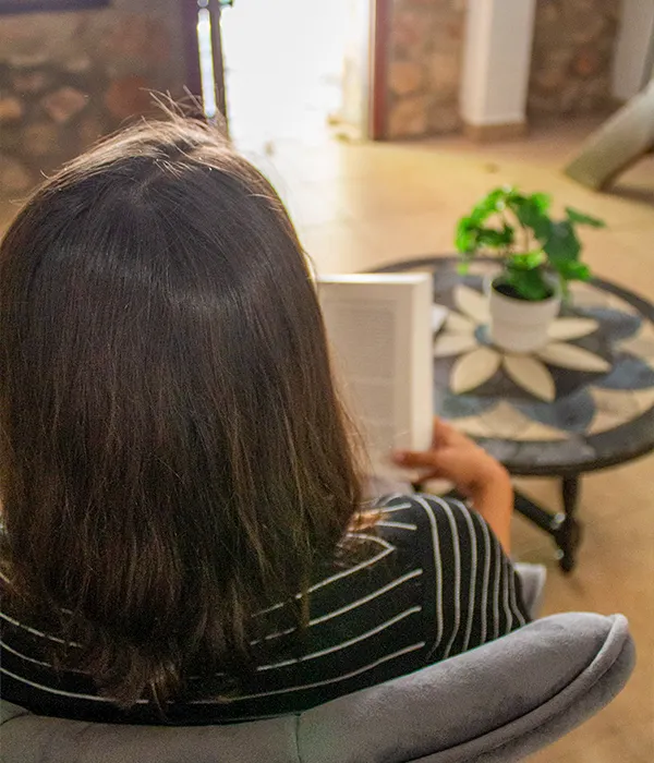 sierra recovery woman sitting chair reading book